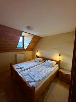 a bedroom with a large bed with a window at Kmetija Matk in Solčava