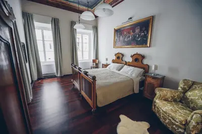 a bedroom with a bed and a couch at Feel Ljubljana Centre in Ljubljana