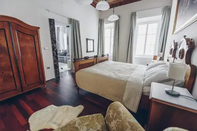 a bedroom with a bed and a table and chairs at Feel Ljubljana Centre in Ljubljana