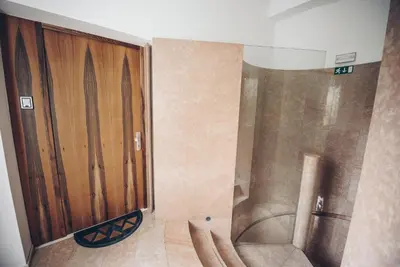 a shower with a wooden door in a bathroom at Feel Ljubljana Centre in Ljubljana