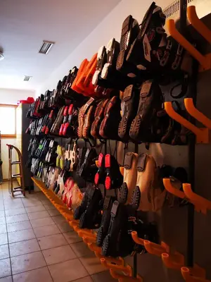 a bunch of shoes are lined up on a shelf at Luxury Apartments Bolf in Pohorje