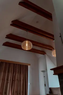 three lights hanging from the ceiling in a room at Luxury Apartments Bolf in Pohorje