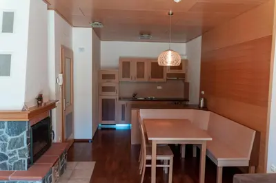 a kitchen with a dining table and a fireplace at Luxury Apartments Bolf in Pohorje