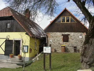 an old building with a sign in front of it at GOSTel Koprivnik pri Kočevju, Kočevski Rog in Koprivnik