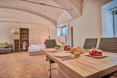 a dining room with a table with fruit on it at Apartment Pod velbi in Ljubljana