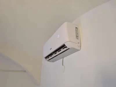 a white toaster hanging on a wall at Apartment Pod velbi in Ljubljana