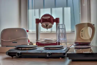 a table with three different types of appliances on it at Apartment Pod velbi in Ljubljana