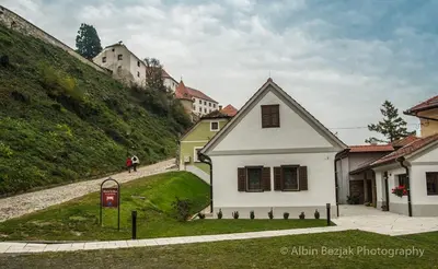 a white house on the side of a hill at Apartment Little house in Ptuj