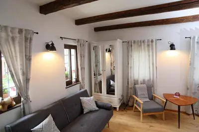a living room with a couch and a table at Apartment Little house in Ptuj