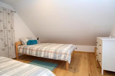 a bedroom with two beds and a dresser at Apartment Little house in Ptuj