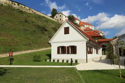 a small white house on the side of a hill at Apartment Little house in Ptuj