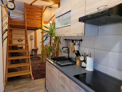 a kitchen with a stove and a counter top at Apartmaji Daniel in Kranjska Gora