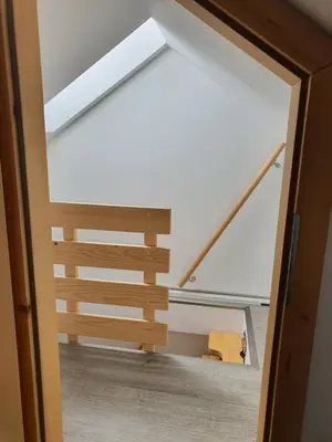 a view through a door into a room with a staircase at Apartmaji Daniel in Kranjska Gora