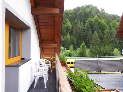 a balcony with a table and chairs on it at Apartmaji Daniel in Kranjska Gora