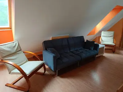 a living room with a couch and two chairs at Apartment Bruna Vučič in Bovec