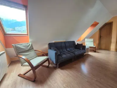 a living room with a couch and two chairs at Apartment Bruna Vučič in Bovec