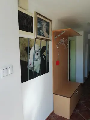 a room with a picture of a cow on the wall at Apartma Pr' Vok in Lesce