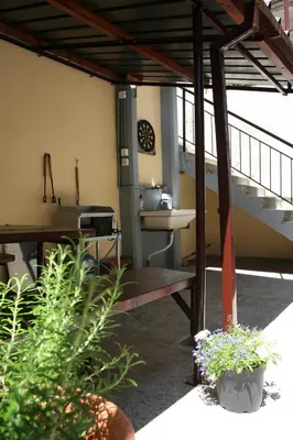 a patio with a sink and a table with plants at Apartma Center in Bovec