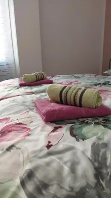 two beds with pillows on them in a bedroom at Apartma Center in Bovec