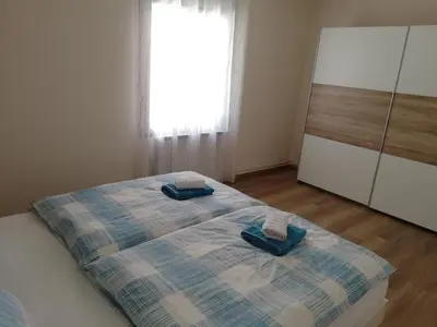 a bedroom with a bed with two towels on it at Apartma Center in Bovec