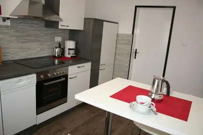 a kitchen with a white table and a white counter top at Apartma Center in Bovec