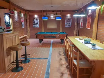 a billiard room with a pool table and a bar at Apartment Feher Lendava in Lendava
