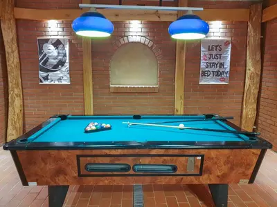 a pool table in a room with blue lights at Apartment Feher Lendava in Lendava