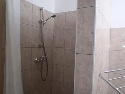 a shower with a glass door at Ribiški dom Radeče in Radeče