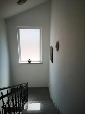 a room with a window and a stair case at Apartma Čeh in Gabrovica pri Črnem Kalu
