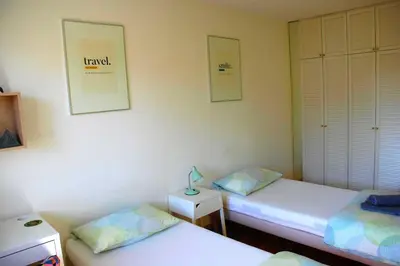 a room with two beds and a lamp on a table at Apartments Peter & Free parking in Ljubljana