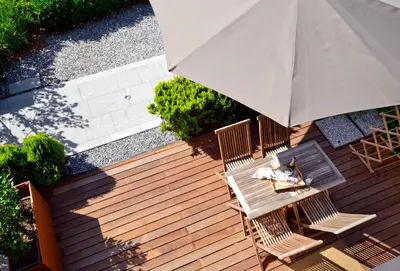 an overhead view of a wooden deck with an umbrella at Apartmaji 43 in Tolmin