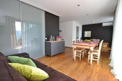 a living room with a table and a dining room at Apartmaji 43 in Tolmin