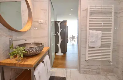 a bathroom with a sink and a mirror at Apartmaji 43 in Tolmin