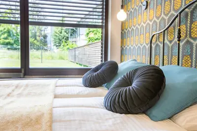 a bed with two bean bags on top of it at Tamara Luxury Apartments in Bled