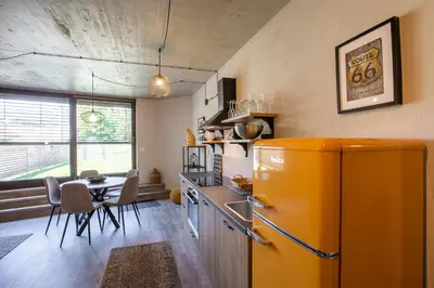 a kitchen with an orange refrigerator and a table at Tamara Luxury Apartments in Bled
