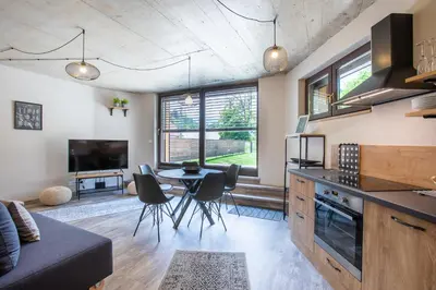 a kitchen and living room with a table and chairs at Tamara Luxury Apartments in Bled