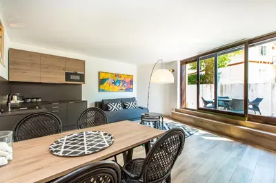 a kitchen and dining room with a wooden table and chairs at Tamara Luxury Apartments in Bled