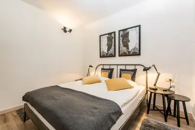 a bedroom with a bed and a table with a lamp at Tamara Luxury Apartments in Bled