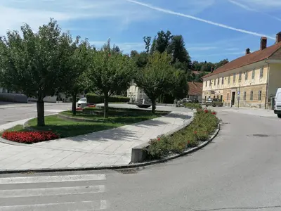 a street with trees and flowers on the side of a road at Apartments Bukor with seasonal pool in Lukovica pri Domžalah