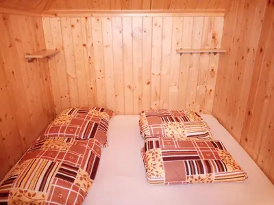 a room with two beds in a sauna at Koča Predilnica Velika Planina in Kamniška Bistrica