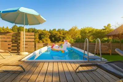 a pool with a unicorn ride in a backyard at Apartma Marija in Metlika