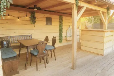 a wooden porch with a wooden table and chairs at Apartma Marija in Metlika