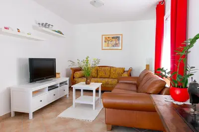 a living room with a couch and a tv at Apartma Marija in Metlika