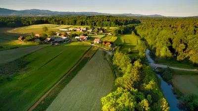 an aerial view of a farm with a river at Apartma Marija in Metlika