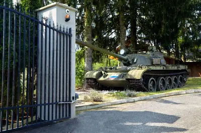 a tank is on display next to a fence at Karavla Private Villa in Šentilj