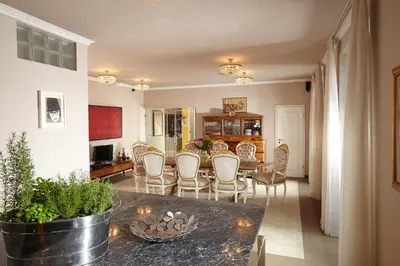 a kitchen and dining room with a table and chairs at Karavla Private Villa in Šentilj