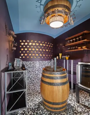 a wine tasting room with a barrel and a chandelier at Karavla Private Villa in Šentilj