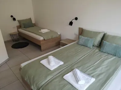 a bedroom with two beds with towels on them at Apartments Ole in Tolmin