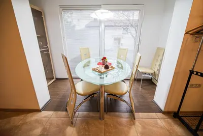a dining room with a glass table and chairs at Apartments Ole in Tolmin