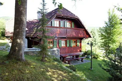 a small wooden house with a bench in front of it at Natural Wooden Sweetheart in Padeški Vrh